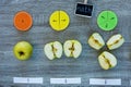 ÃÂ¡olorful math fractions and apples as a sample on wooden background or table. Interesting creative funny math for kids.